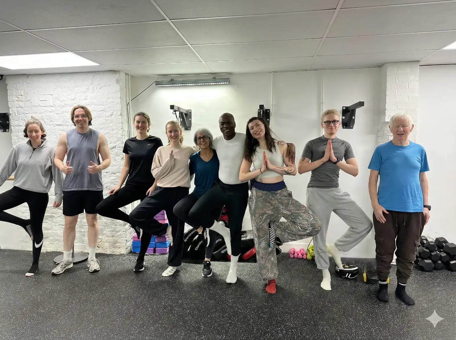 Yoga community group in tree pose at Archway Wellness Centre