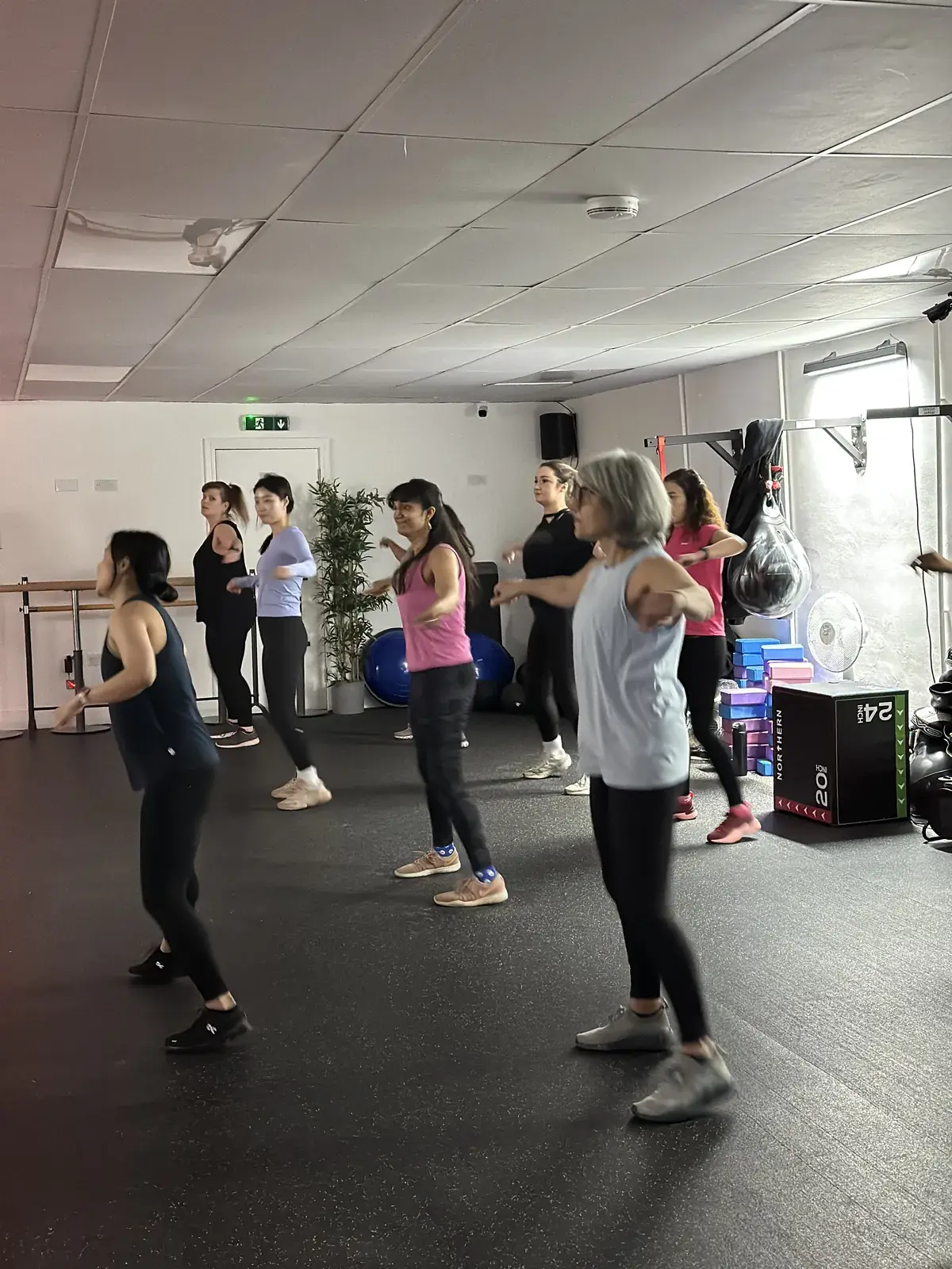 Mixed-ages Zumba class following the steps together